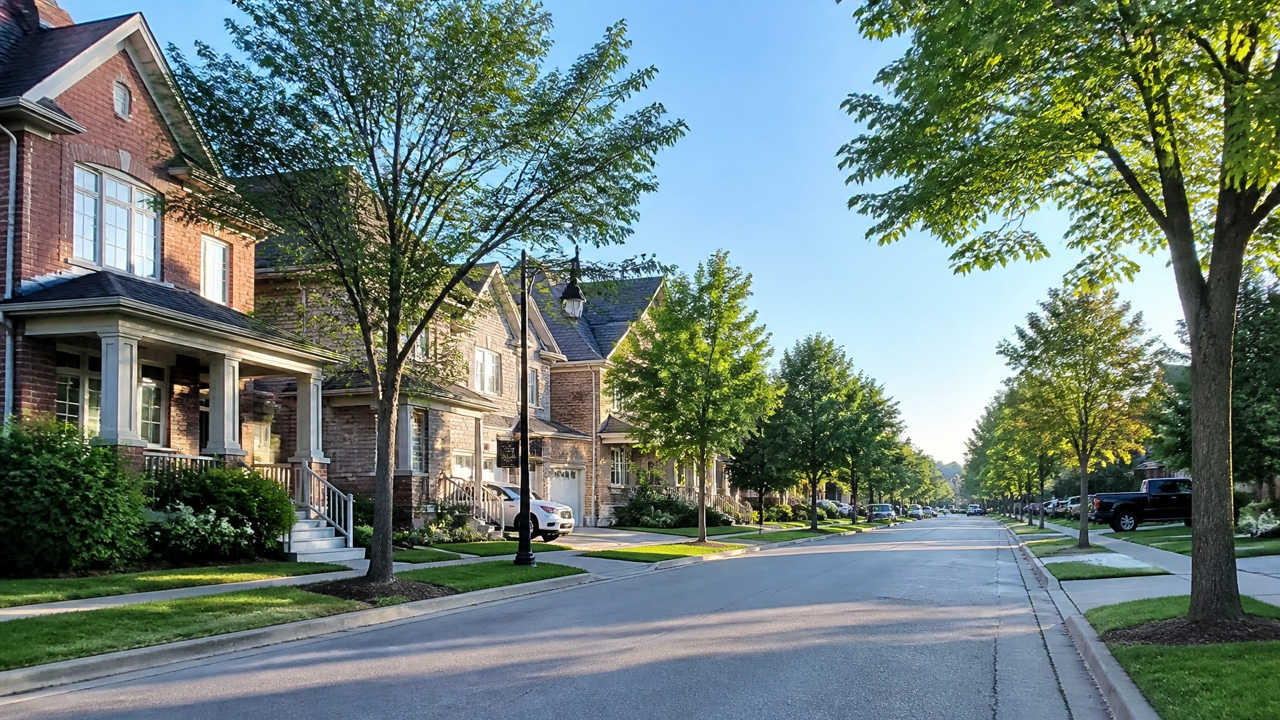 A leafy, orderly suburban street in Ontario, representing the aspirational lifestyle found in communities like Aurora and Newmarket.